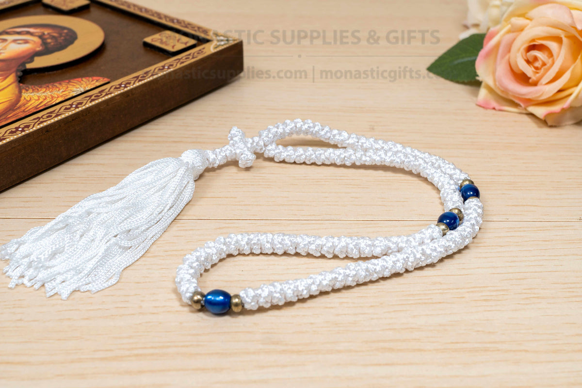 White 100 knots prayer rope komboskini with blue divider beads and cross made in Greece