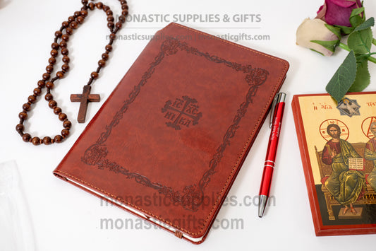 Orthodox embossed brown leather notebook set featuring an elastic band closure, ribbon bookmark, hidden back compartment, and a luxury Jesus Prayer inscribed pen.
