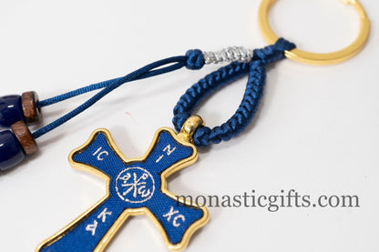 Christian keychain in the shape of a cross , embroidered fabric with the symbols of Jesus Christ in blue color ,a perfect Religious Gift .